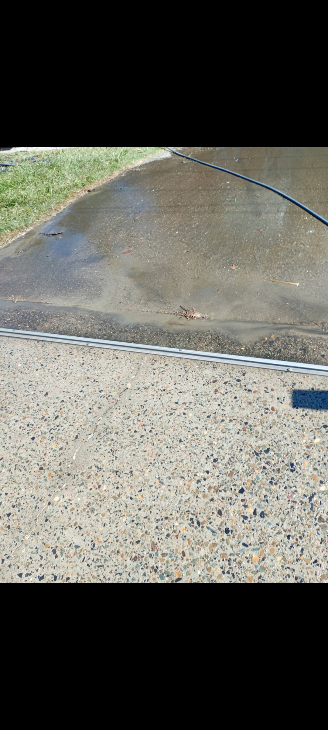 Dirty concrete edge before pressure washing