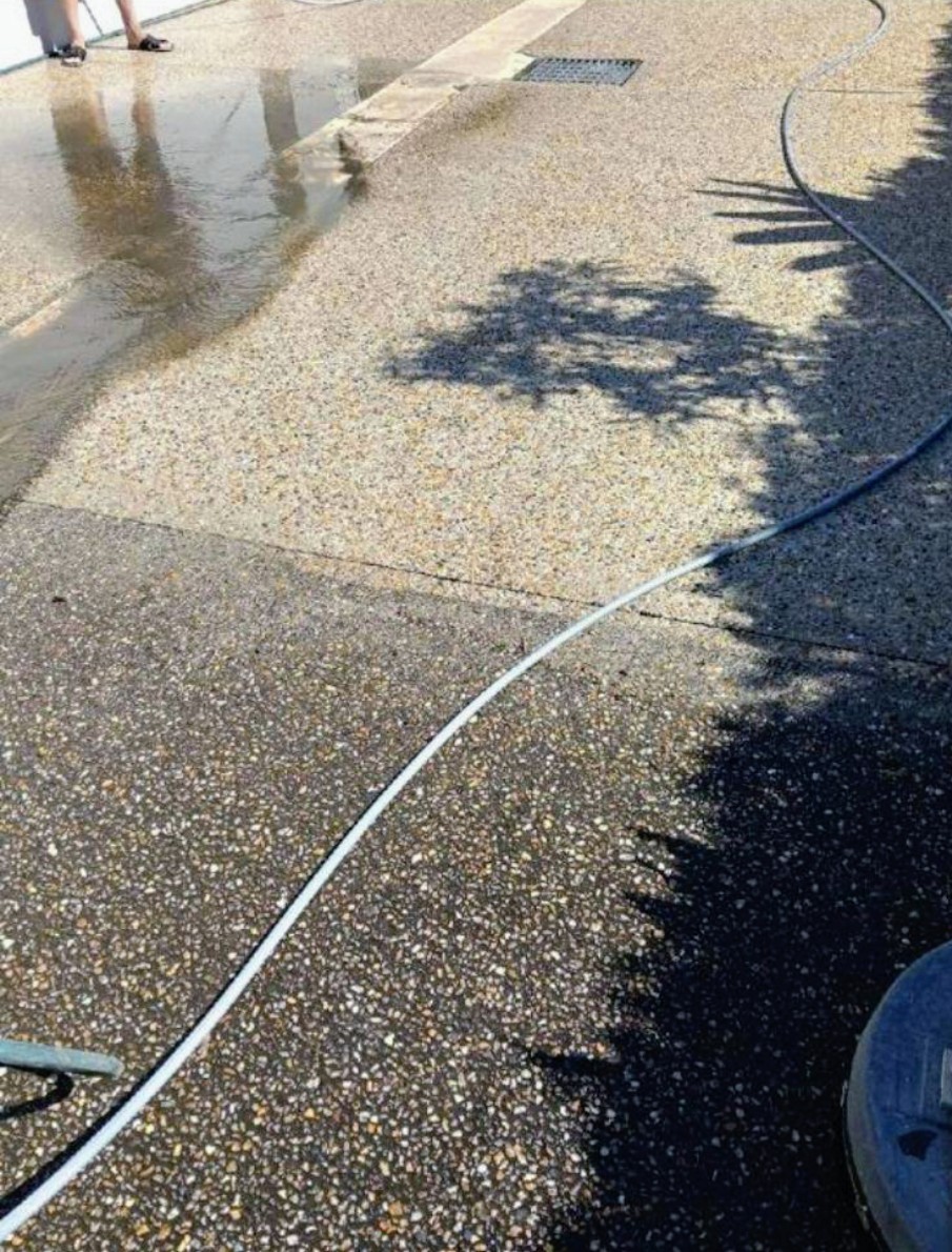 Exposed aggregate driveway during cleaning